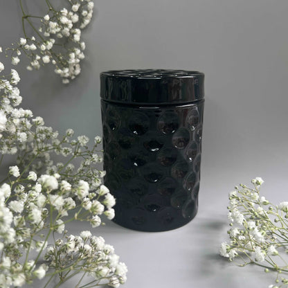 black jar candle with lid on